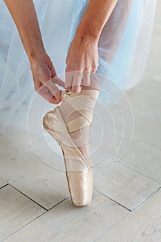 Ballerina puts pointe shoes