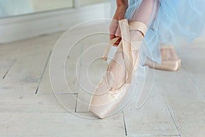 Ballerina puts pointe shoes