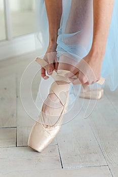 Ballerina puts pointe shoes