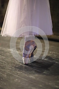 Ballerina`s feet in pointe shoes