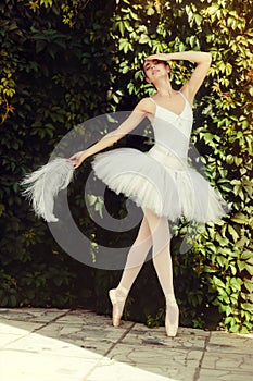 Ballerina sensually dances in nature. photo