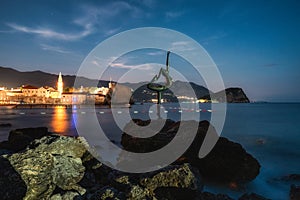 Ballerina statue and Budva Old town at background in Montenegro