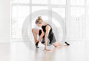 Ballerina stretching in ballet school