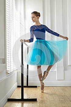 Ballerina is training on barre