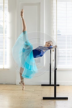 Ballerina is training on barre