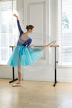Ballerina is training on barre