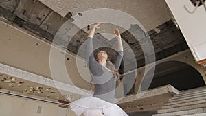 A ballerina trains in an abandoned building