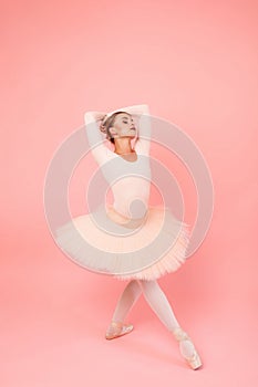 Ballerina in tutu dancing indoors