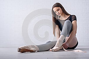 Ballerina tying shoes