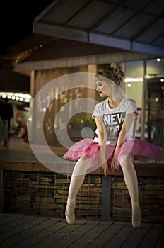 Ballerina in an urban nighttime setting