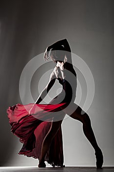 Ballerina with a waving red dress