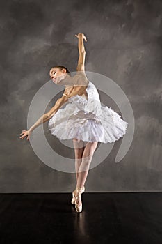 Ballerina in white tutu, dancing in the studio in Connecticut