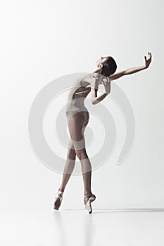 Ballerina. Young graceful female ballet dancer dancing isolated on white. Beauty of classic ballet.