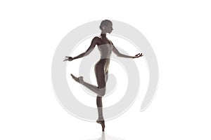 Ballerina. Young graceful female ballet dancer dancing isolated on white. Beauty of classic ballet.