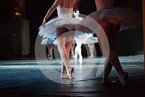 Ballerinas in the movement. Feet of ballerinas close up.