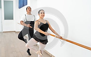 ballet couple partners preparing in rehearsal for a contest hispanic ballerina warming up with african american male ballet