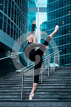 Ballet dancer on attitude pose on cuty street background photo