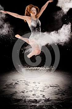 Ballet dancer ballerina jumping white powder