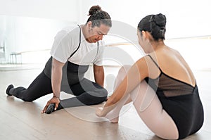 ballet dancer couple stretching and warming up before exercise a performance. getting ready to practice in a ballet dance studio