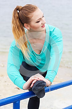 Ballet dancer doing stretching near the sea