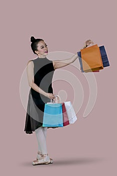 Ballet dancer holding shopping bags