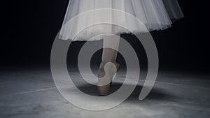 Ballet dancer legs dancing on tiptoe. Ballerina feet doing steps in pointe shoes