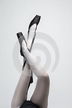 Ballet Dancer Legs In Laced Pointes Shoes. Posing With Lifted Crossed Legs