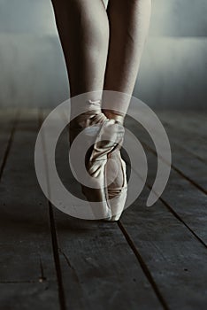 Ballet dancer legs standing on the tiptoes in pointes