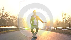 A ballet dancer performs an anthrax jump in the middle of the road at dawn, leaks. Slow motion