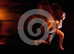 Ballet dancer posing on black studio background