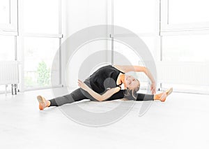 Teen girl making ballet stretches