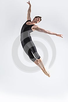 Ballet Dancer Young Man in Black Dance Suit Posing in Flying Ballanced Dance Pose Studio photo