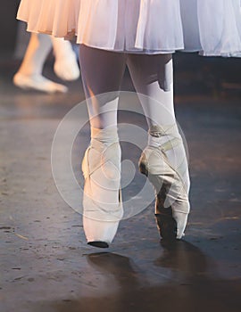 Ballet dancers couple during performance repetition, classic ballet rehearsal practicing in ballroom, view of legs in pointe shoes
