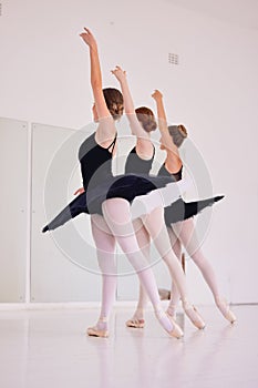 Ballet dancers dancing and practicing in a dance studio together preparing for a performance. Group of elegant, skilled