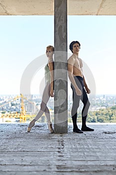 Ballet dancers posing at unfinished building