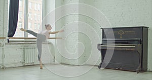 Ballet dancers practicing adagio in rehearsal room