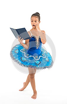 Ballet girl with book. Small girl study and train, education. Small ballerina reading book. She is in love with ballet