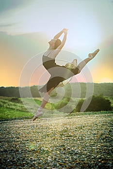 Ballet girl dancer jump at sunset