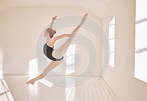 Ballet, jump and performance dance studio with young student. Dancer girl with energy in  classroom and moving