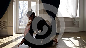 ballet performers are rehearsing contemporary choreography in hall, young man and woman are dancing together