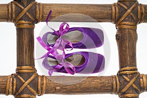 Ballet pointe shoes black in wooden frame on white background