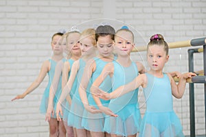 Ballet school. Little girls students practicing near barre .Middle shot of ballerinas in dance class.