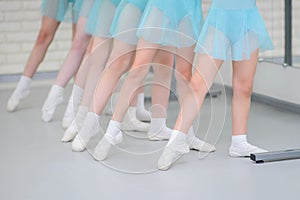 Ballet school. Little girls students practicing near barre work for feet positions .Closeup detail shot of feets in