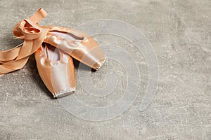 Ballet shoes. Elegant pointes on grey textured background, space for text