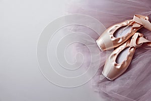 Ballet shoes. Elegant pointes and tutu on light grey background, top view. Space for text