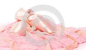 Ballet shoes on a pink cloth isolated