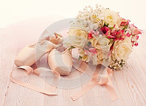 Ballet shoes. Pointe shoes on wooden background.