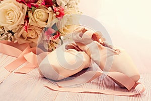 Ballet shoes. Pointe shoes on wooden background.