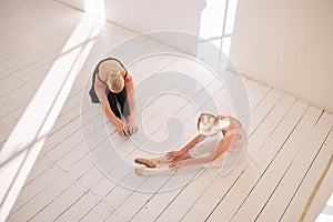 Ballet stretching, dance student and teacher in studio for theatre performance, dancing education and creative art