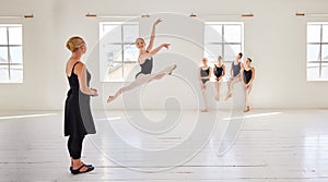 Ballet teacher, dance students and studio with group diversity of ballerina dancers in creative theatre jump performance